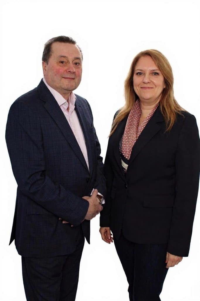 Photo of a man and woman in business suits
